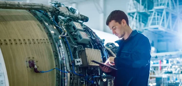 engineer overhauling an aircraft engine